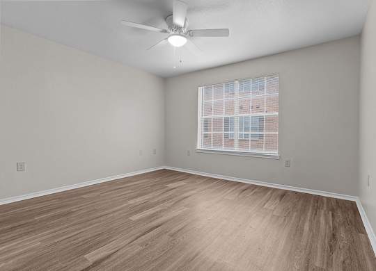 Modern Bedroom with ceiling fan at Valley Ridge Apartments in Lewisville TX