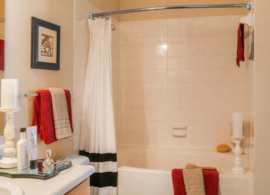 Bath tub with tile surround at River Pointe at Den Rock Apartments in Lawrence, MA