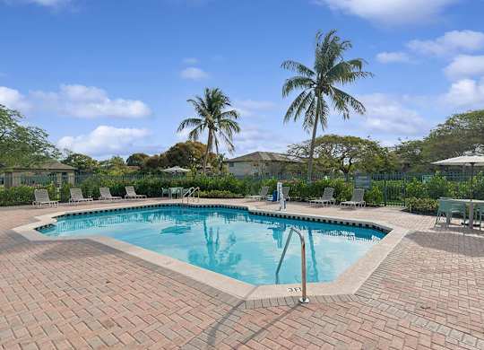 Pool with landscaping at Running Brook Apartments in Miami FL