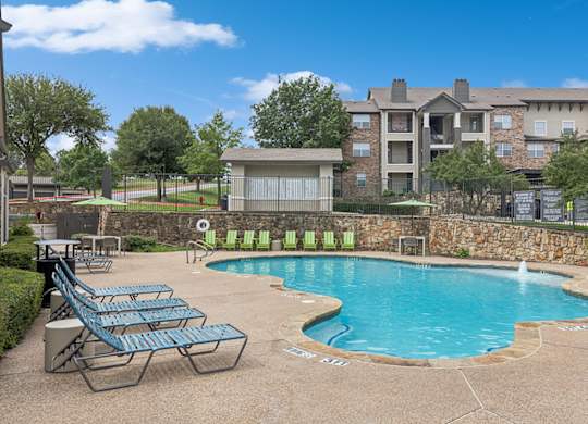 Pool with lounge chairs at Cypress View Villa Apartments in Weatherford TX
