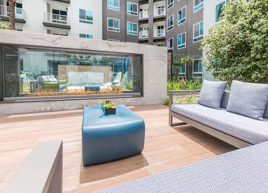 Seating area around pool at Avel Apartment Homes in Orange CA