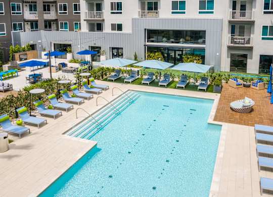 Pool with lounge chairs at Avel Apartment Homes in Orange CA