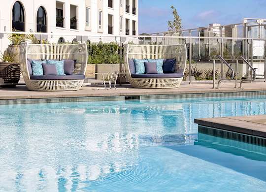 Pool day beds at Chromatic Flats Apartments in San Diego CA