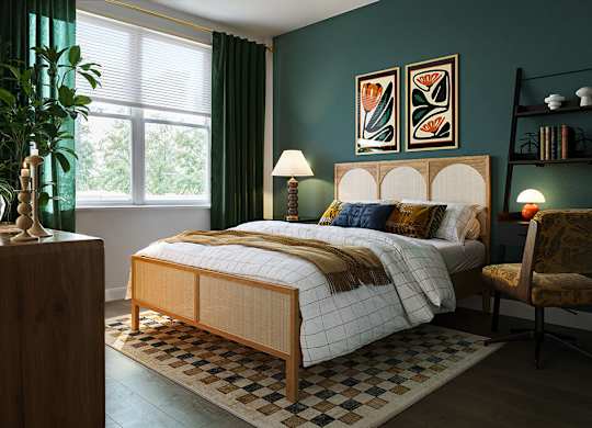 Bedroom with green accent wall at Merrick on Midway Apartments in Farmers Branch TX