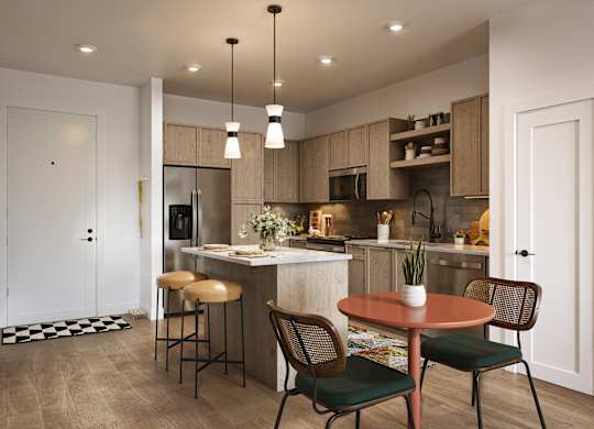 A kitchen with a table and chairs in the foreground and a bar area in the background.