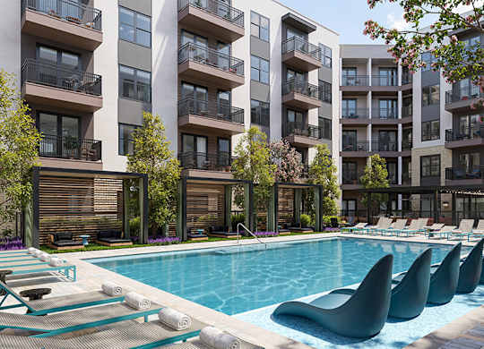 Outdoor pool and chairs at Merrick on Midway Apartments in Farmers Branch TX