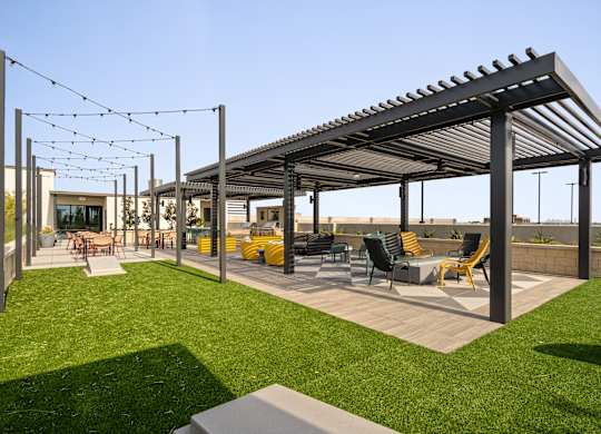 A patio with a roof and chairs.