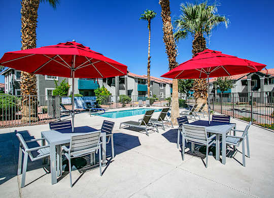 our apartments have a pool and tables with umbrellas