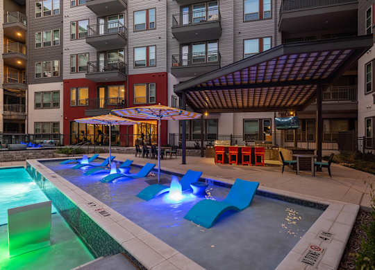 Shallow water pool with tanning chairs at Opal Legacy Central in Plano TX