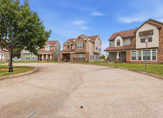 A residential area with houses and a tree.