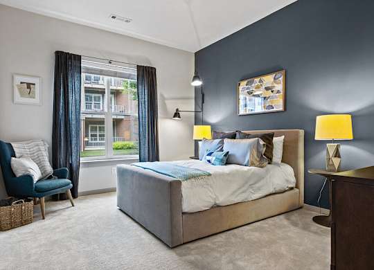 Model bedroom with large window at The Slate at Andover Apartments in Andover MA