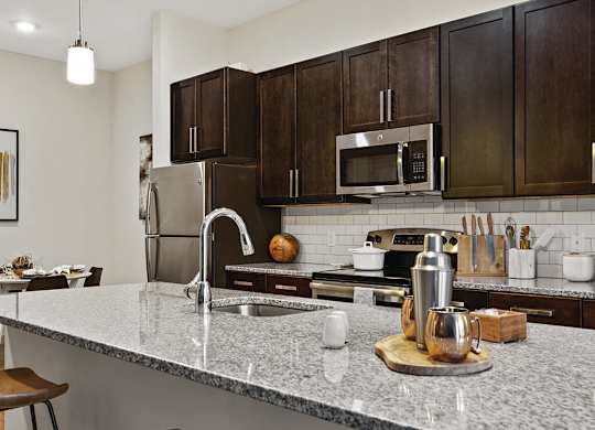 Kitchen with white countertops at The Slate at Andover Apartments in Andover MA