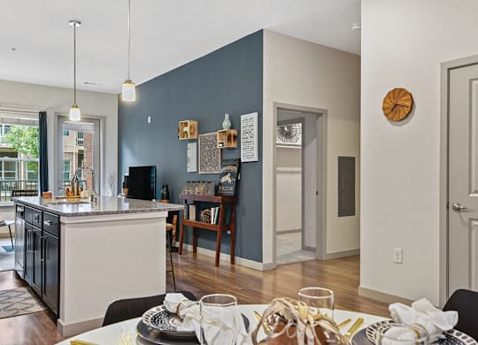 View of living room with kitchen at The Slate at Andover Apartments in Andover MA