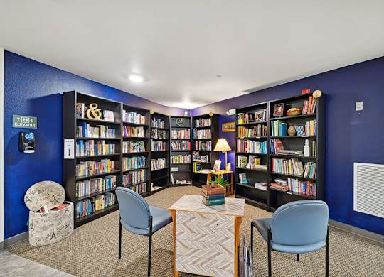 Social lounge reading area at Woodlands at Forbes Lake Apartments in Kirkland WA