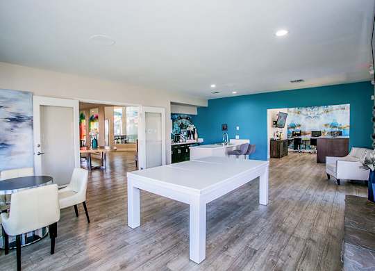 a dining room with a white table and chairs