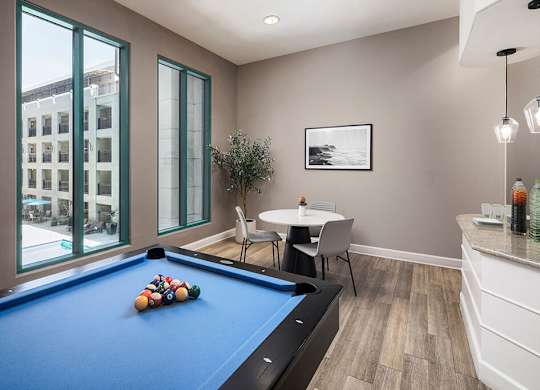 Social lounge game area at Caprielle Apartments in San Diego CA