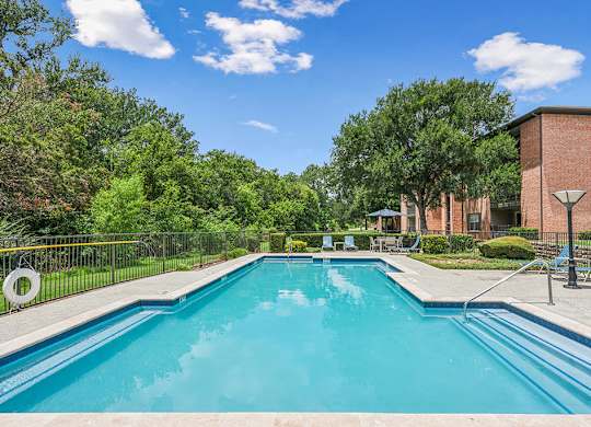 Swimming pool with patio access at Valley Ridge Apartments in Lewisville TX