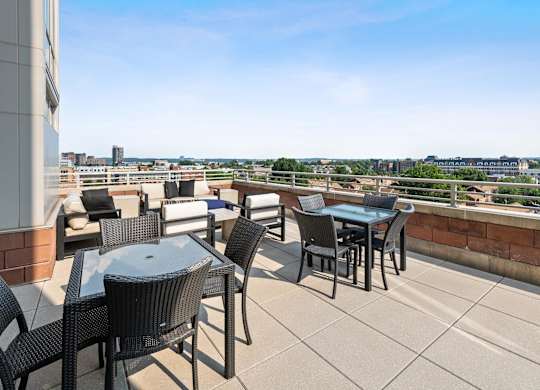 Tabes and chairs on rooftop terrace at Bradley Braddock Road Station Apartments in Alexandria VA