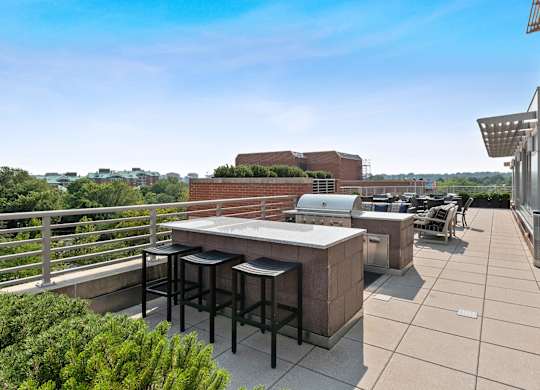 Outdoor terrace grilling area at Bradley Braddock Road Station Apartments in Alexandria VA