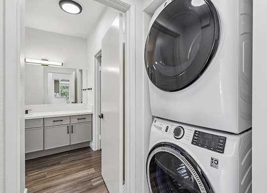 A white washing machine in a laundry room.