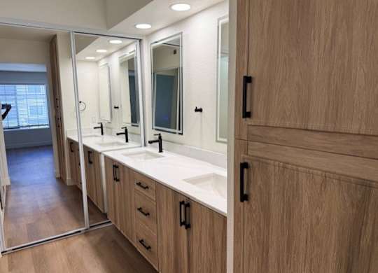 A bathroom with a vanity and a mirror.