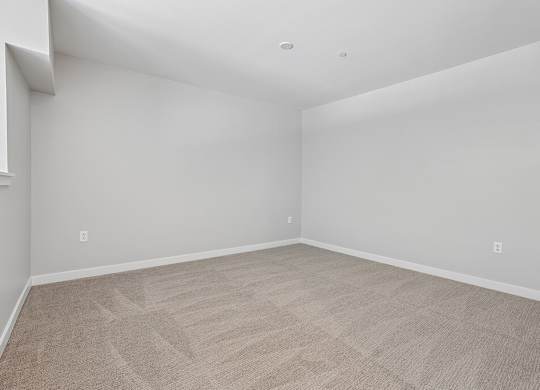 A room with a carpeted floor and white walls.