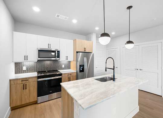 Herringbone Design Package Kitchen Angled at East Bend Apartments in Houston TX