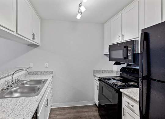 Black kitchen appliances at Hilltop Commons Apartments in San Pablo CA