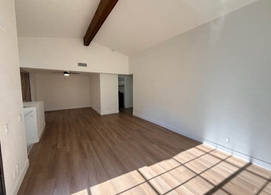 A room with wooden floors and white walls.
