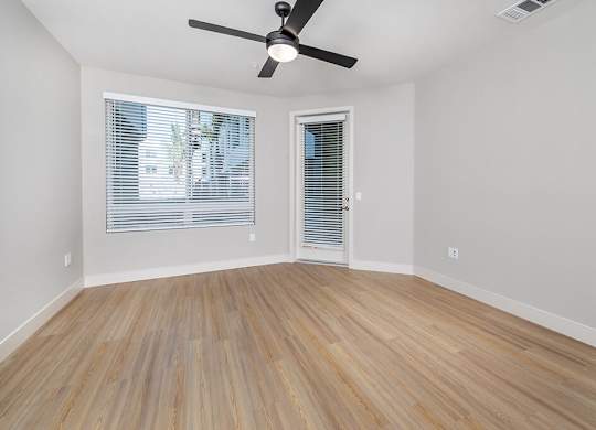 Vacant Metallic Rose Design Package Living Room at Bowen Apartments in San Diego CA