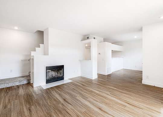 Living room with fireplace at Marquessa Villas Apartmetns and Townhomes in Corona CA 