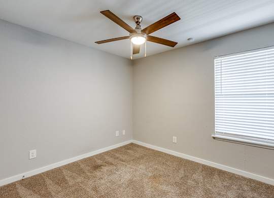 Second bedroom with carpet at Mission James Place Apartments in Austin TX