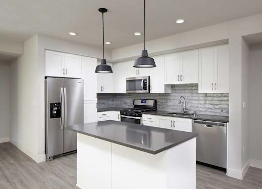 Vacant Slate Design Package Kitchen with island at The Seaton Apartments in San Diego CA