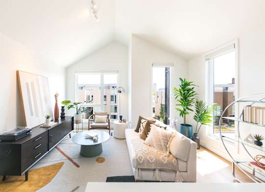 A living room with a white couch and a coffee table.