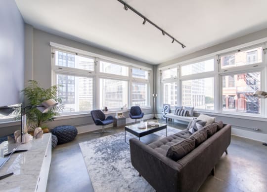 Living Room with a Couch and Large Windows at Fourteen56, Detroit, MI