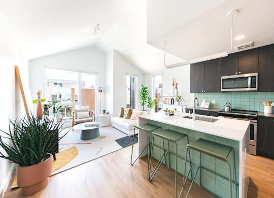 A modern kitchen with a bar stool and a countertop.