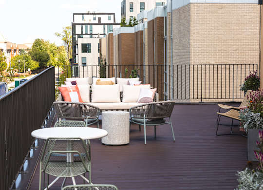 A patio with a white table and chairs.
