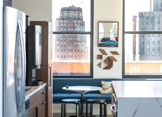 Gourmet kitchen with island, modern appliances, and elegant backsplash at The Stott.
