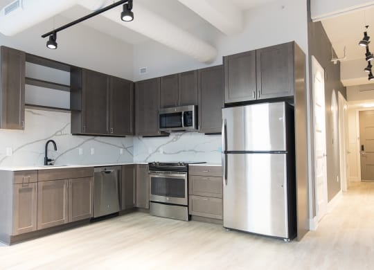 Kitchen with hardwood floors and stainless steel appliances at 35W in Detroit. MI