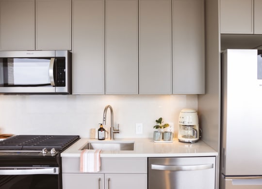 Studio unit with a kitchen with stainless steel appliances and cabinets at Book Tower, Michigan, 48226
