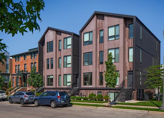 a group of buildings with cars parked in front of them