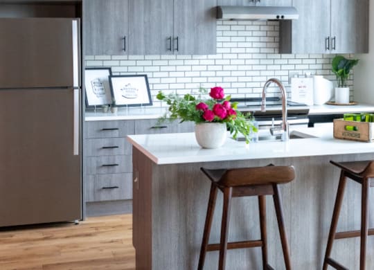 Kitchen with Island and Grey Cabinets at The Assembly, Detroit, MI