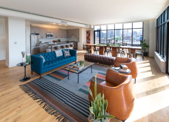 Living Area with a Blue Couch and Carpeting at The Assembly, Detroit, MI