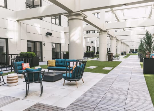 Outdoor community atrium with seating and built-in fire pits at The May.