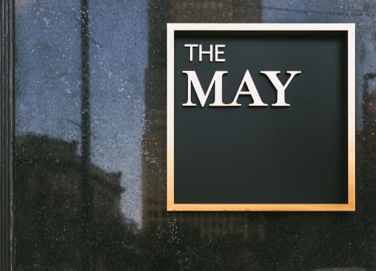 The May, exterior signage in gold.