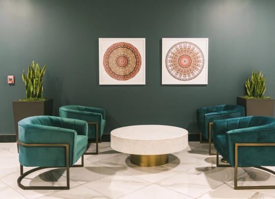 Interior lounge area with elegant furnishings and art work at The May.