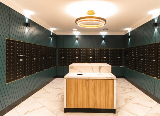 Mail room with forest green walls and private mailboxes at The May.