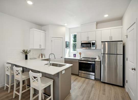 Tile backsplash, quartz counters, and abundant storage. at Holmes Park Townhomes, Oregon City