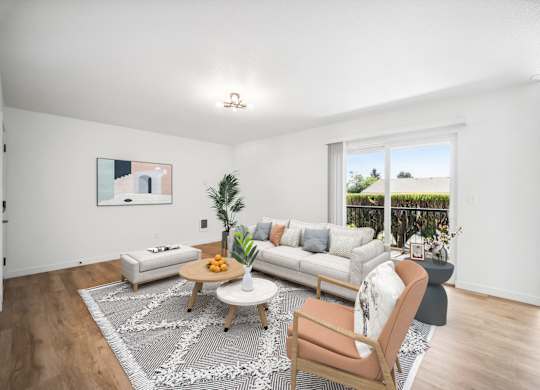 A living room with a white couch, a wooden chair, and a coffee table.