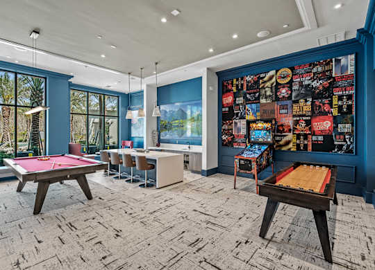 a game room with pool tables and a wall covered in posters at Altis Grand Suncoast, Florida, 34638